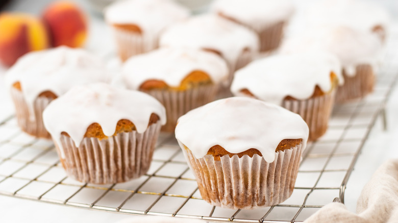 glazed peach muffins on wire rack