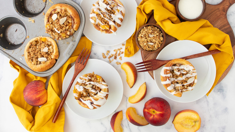 cinnamon rolls with sliced peaches