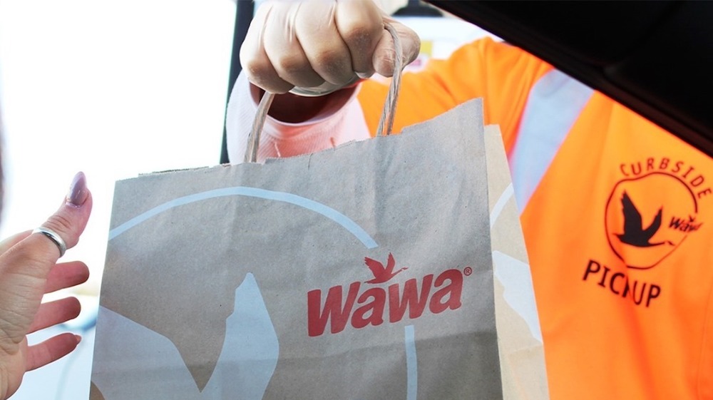 Wawa employee handing over food bag