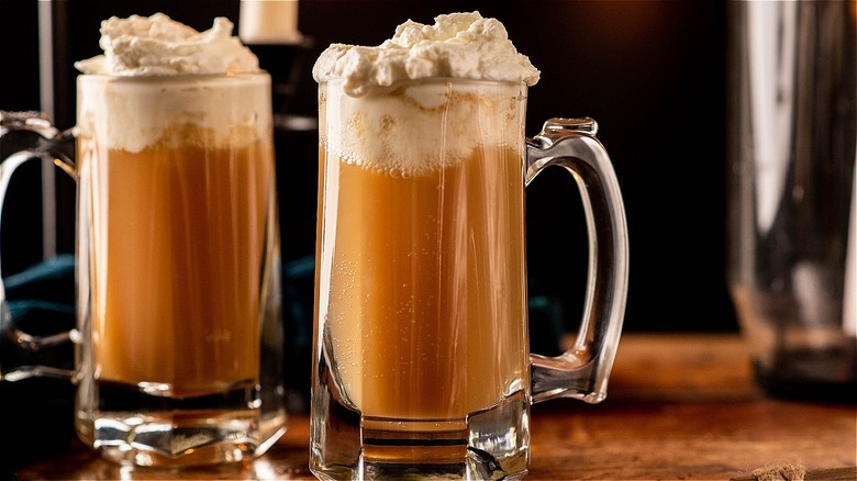 two mugs of butterbeer on table