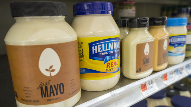 Pouring mayonnaise over a sandwich