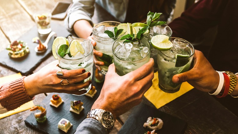 group toasting cocktails 