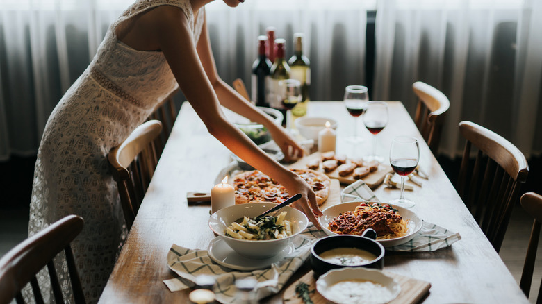 Woman putting together dinner party table 