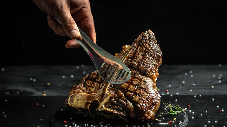 Chef handling cooked steak