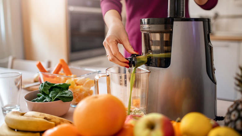 person using juicer