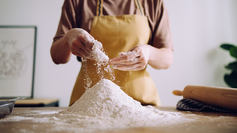 Woman sprinkling flour