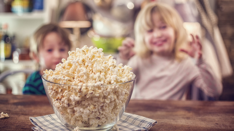 popcorn on the table kids in the background