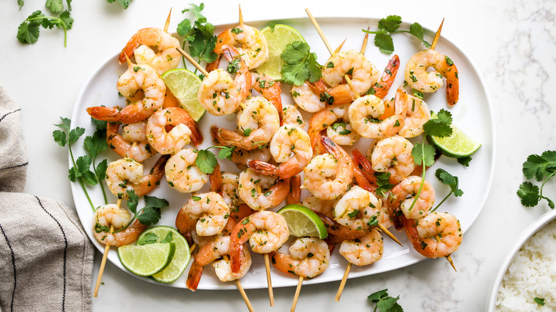 shrimp skewers on white plate