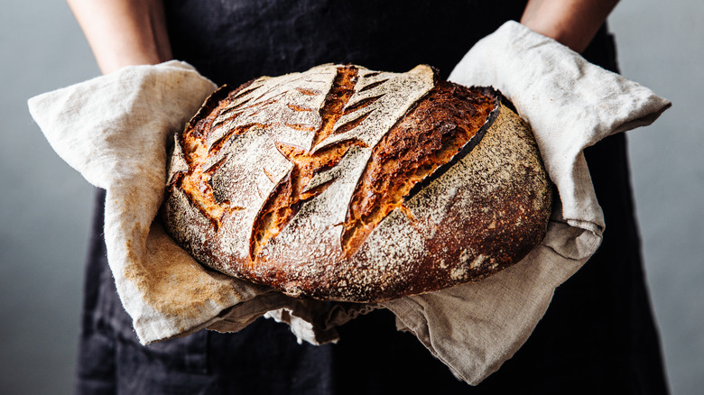 Person holding sourdough loaf