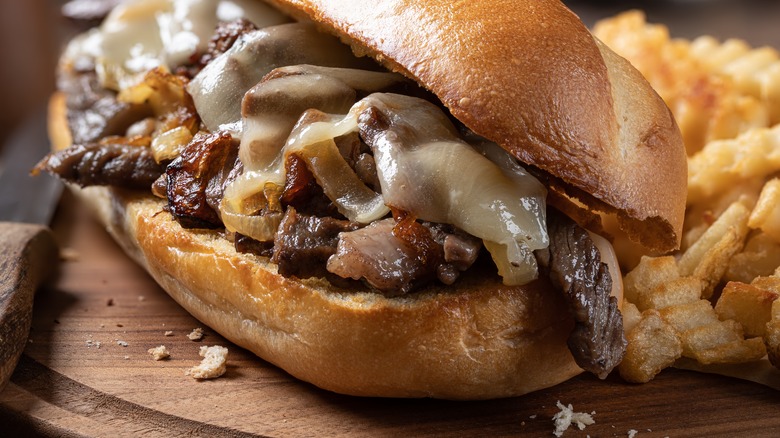 Philly cheesesteak sandwich and fries