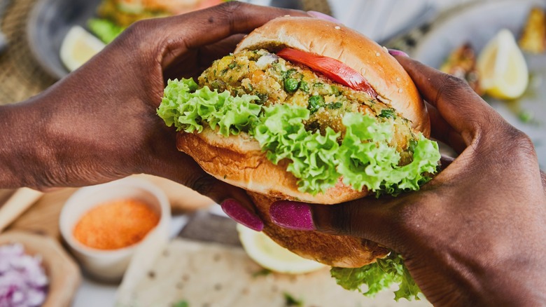 Woman holding a vegetarian hamburger