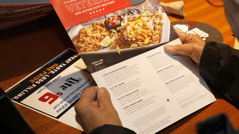 Man reading Aplebee's menu 