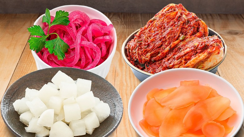 various pickled fruits and vegetables in bowls