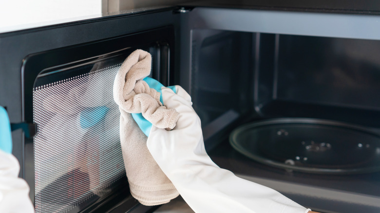 Person putting bowl in microwave