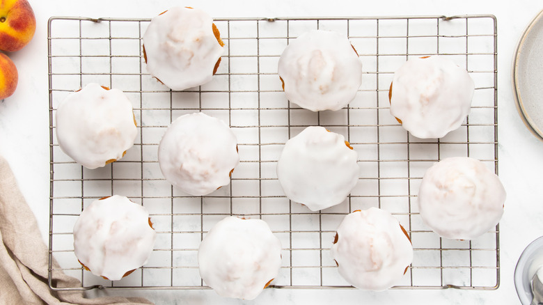 glazed peach muffins on wire rack