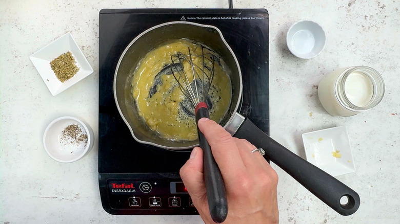 whisking roux in saucepan