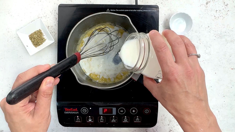 adding milk to saucepan