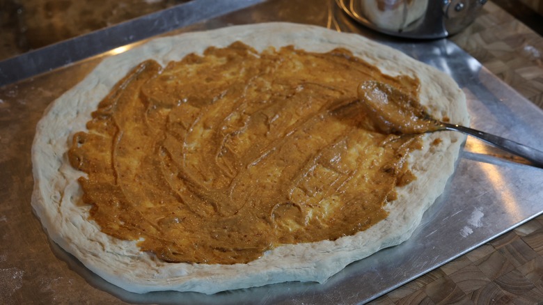 pizza dough spread with peanut sauce