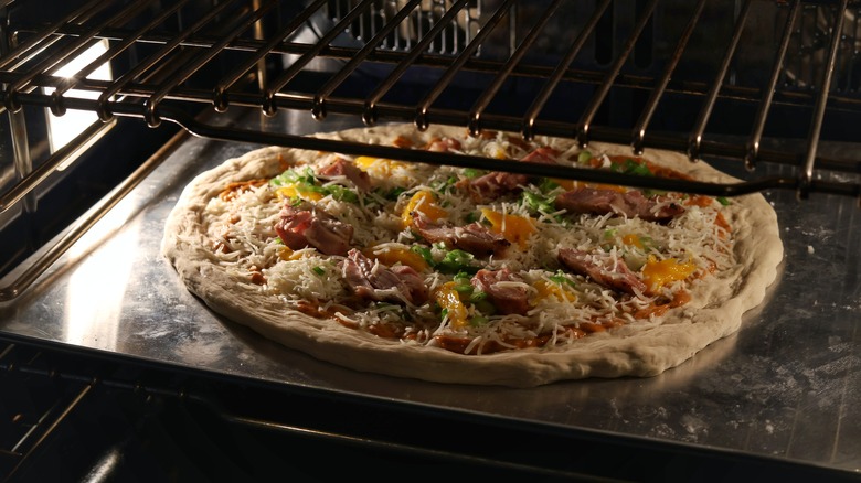 thai chicken pizza in oven