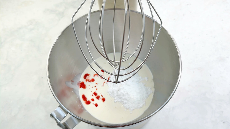 cream, strawberries and sugar in food mixer bowl