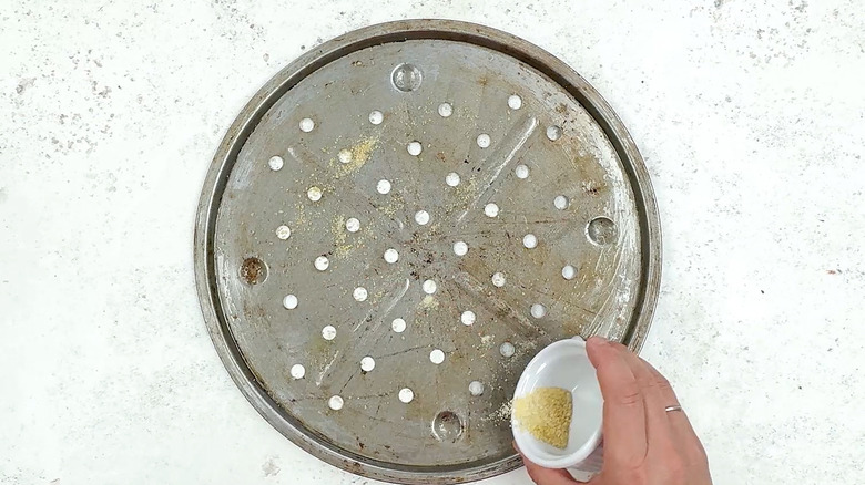 dusting pizza pan with cornmeal