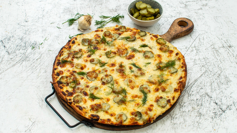 dill pickle pizza on wooden board