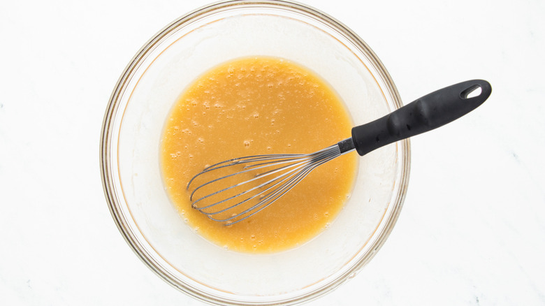 mixing wet muffin ingredients in bowl