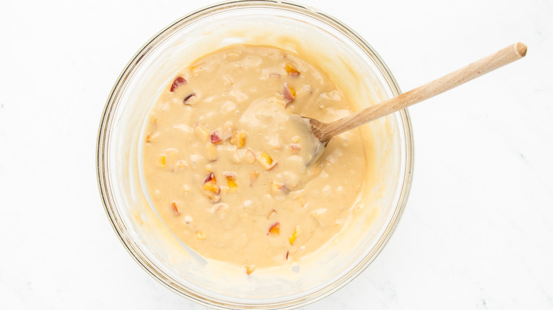 peach muffin batter in mixing bowl