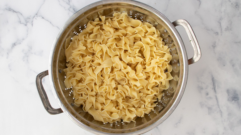 cooked noodles in colander