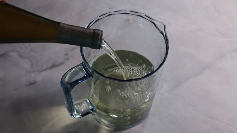 pouring wine into pitcher