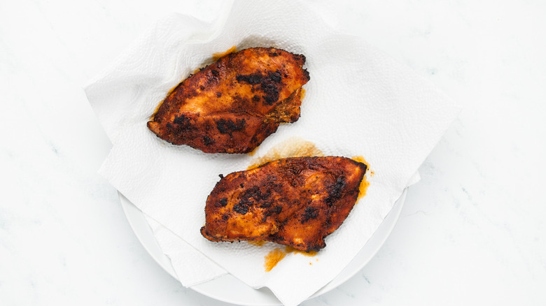 draining fried chicken breasts