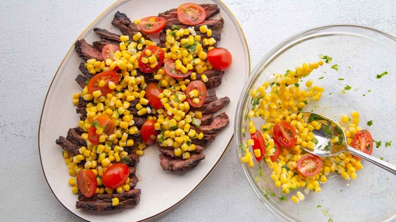 skirt steak topped with tomato and corn salsa